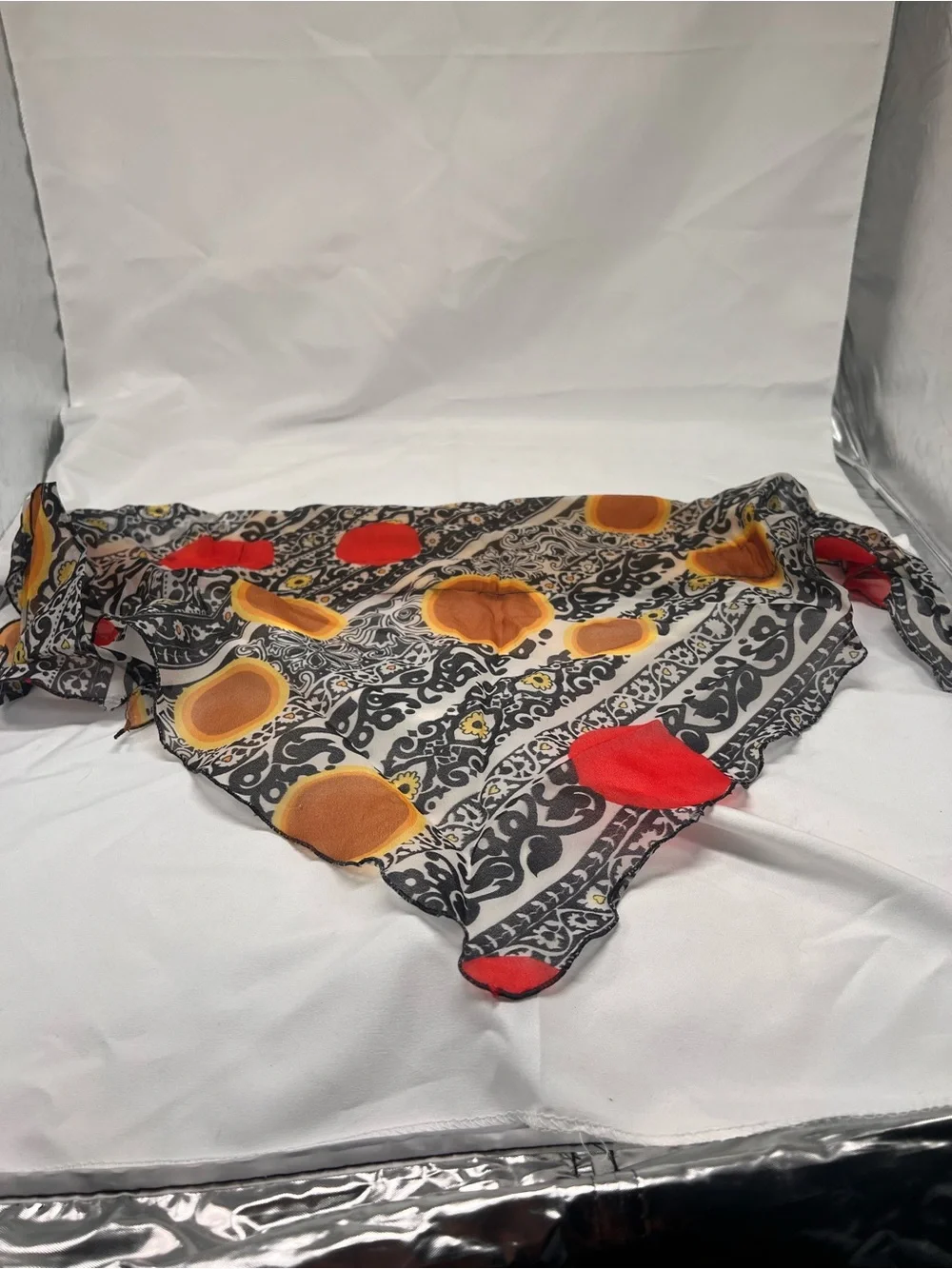 Black Patterned Scarf with Red and Mustard Dots triangle shape.